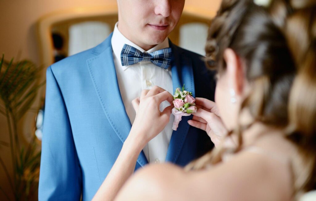 100+ Wedding Photography ideas to capture every moment 56 Bride helping groom with floral pin
