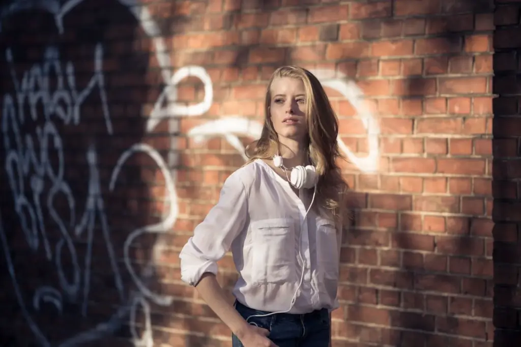 100+ Portrait Photography Ideas for Every Occasion and Style 110 Against a textured wall in natural shade