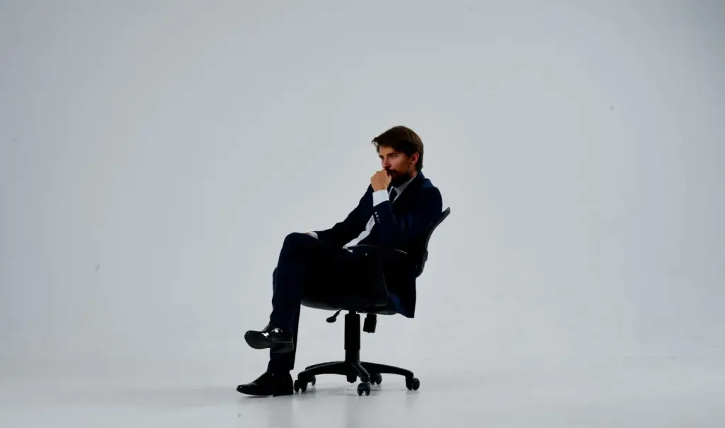 100+ Portrait Photography Ideas for Every Occasion and Style 24 Casual seated on a work chair