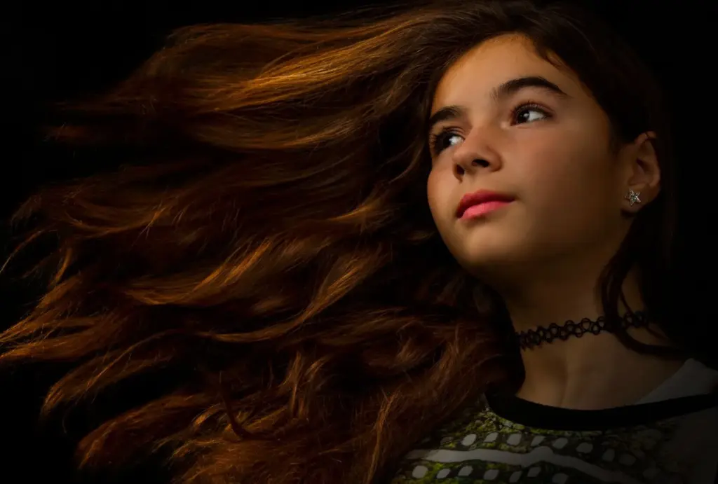 100+ Portrait Photography Ideas for Every Occasion and Style 64 Dramatic hair flip, looking at the camera