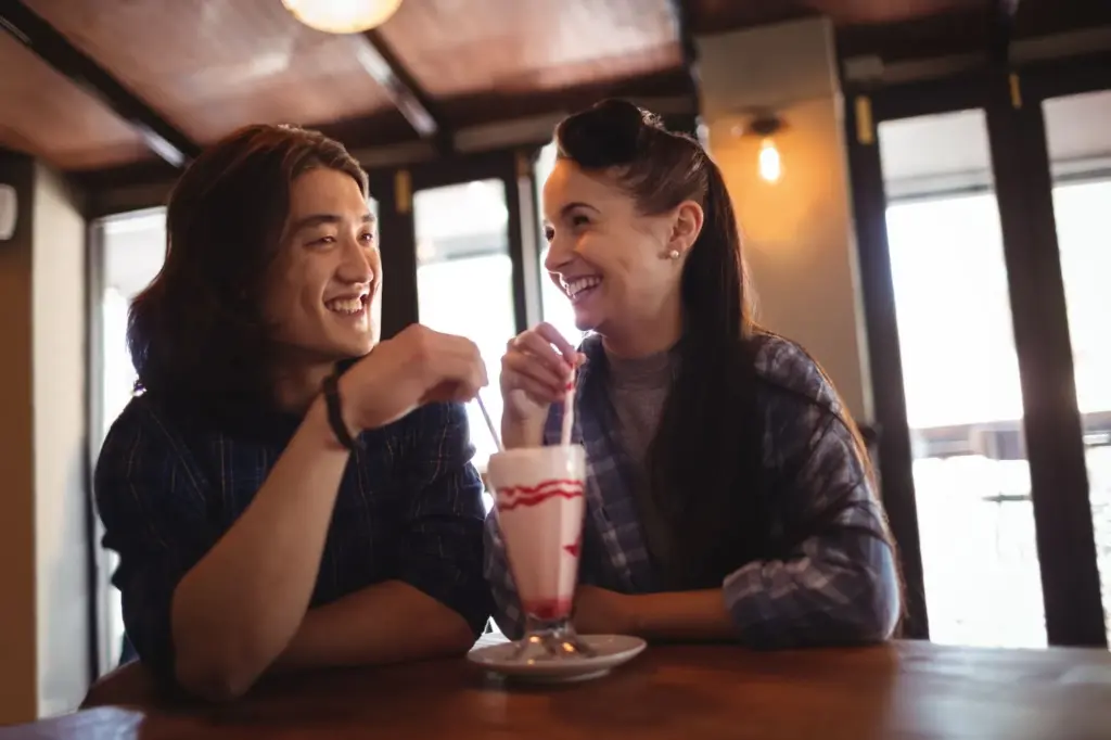 100+ Portrait Photography Ideas for Every Occasion and Style 99 Sharing a drink in a cafe