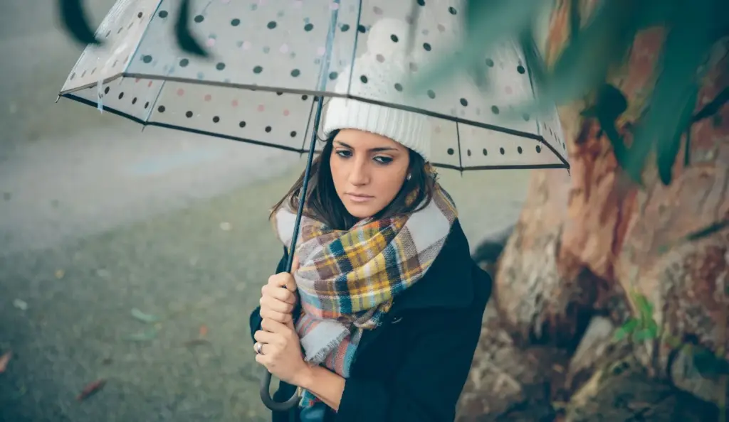 100+ Portrait Photography Ideas for Every Occasion and Style 49 Under an umbrella in the rain