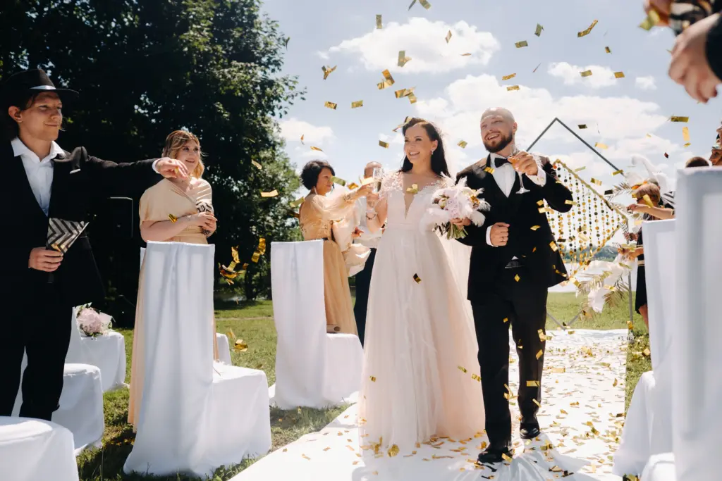20+ Creative Group Wedding Photo Ideas for Family and Friends 70 A happy wedding couple with glasses of wine passes along the guests