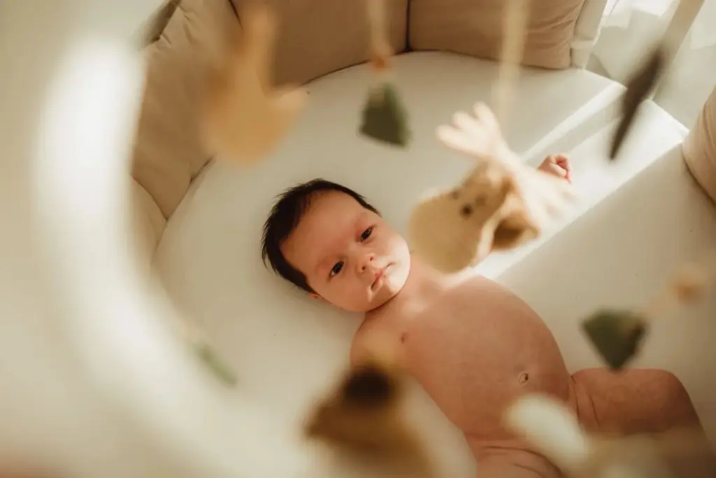 Baby in a cradle under sunlight
