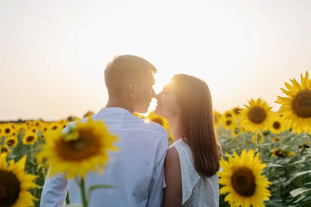 Backlit golden hour shot with sunflowers and joyful expressions