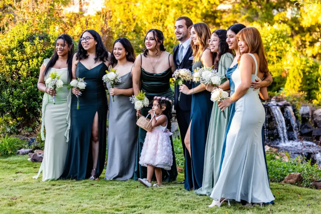 Bridal party with bride under garden blooms