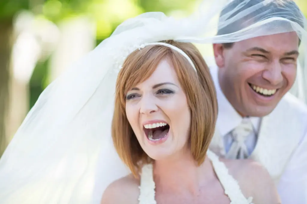 Bride and groom bursting into laughter