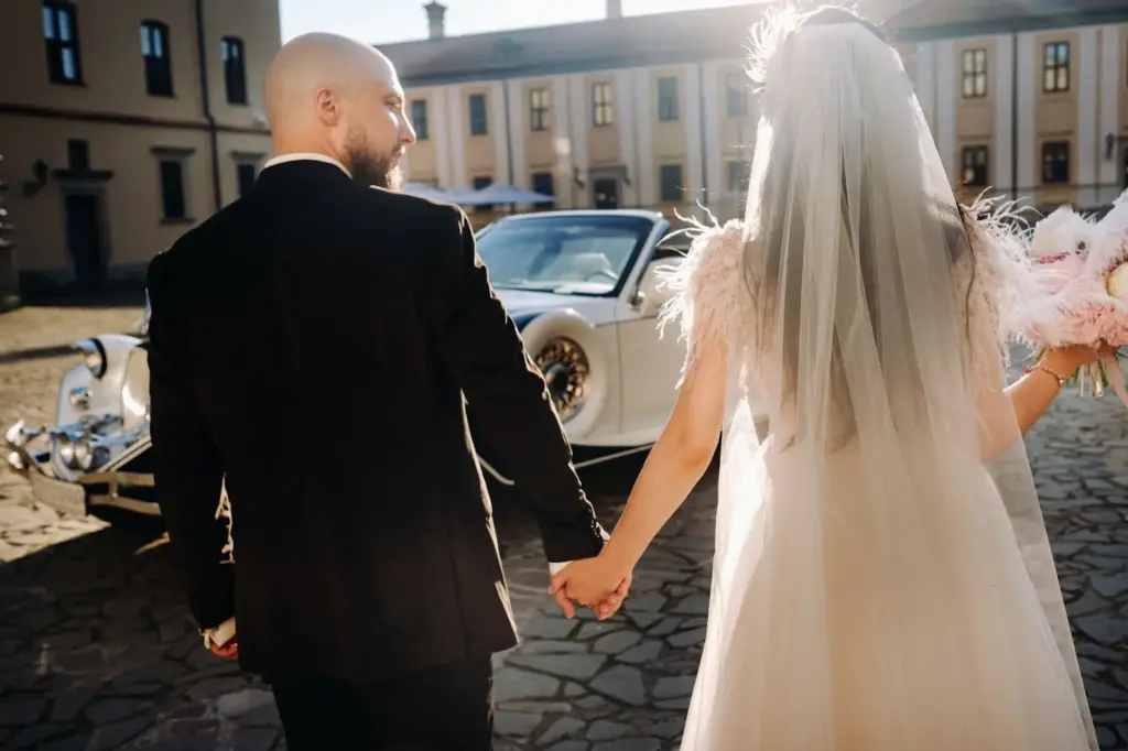 Bride and groom holding hands tightly as they leave