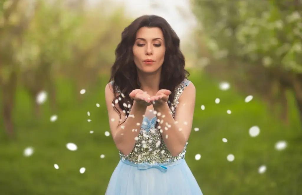 Bride blowing petals toward the camera