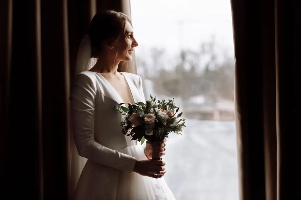 Bride gazing out the window, lost in thought