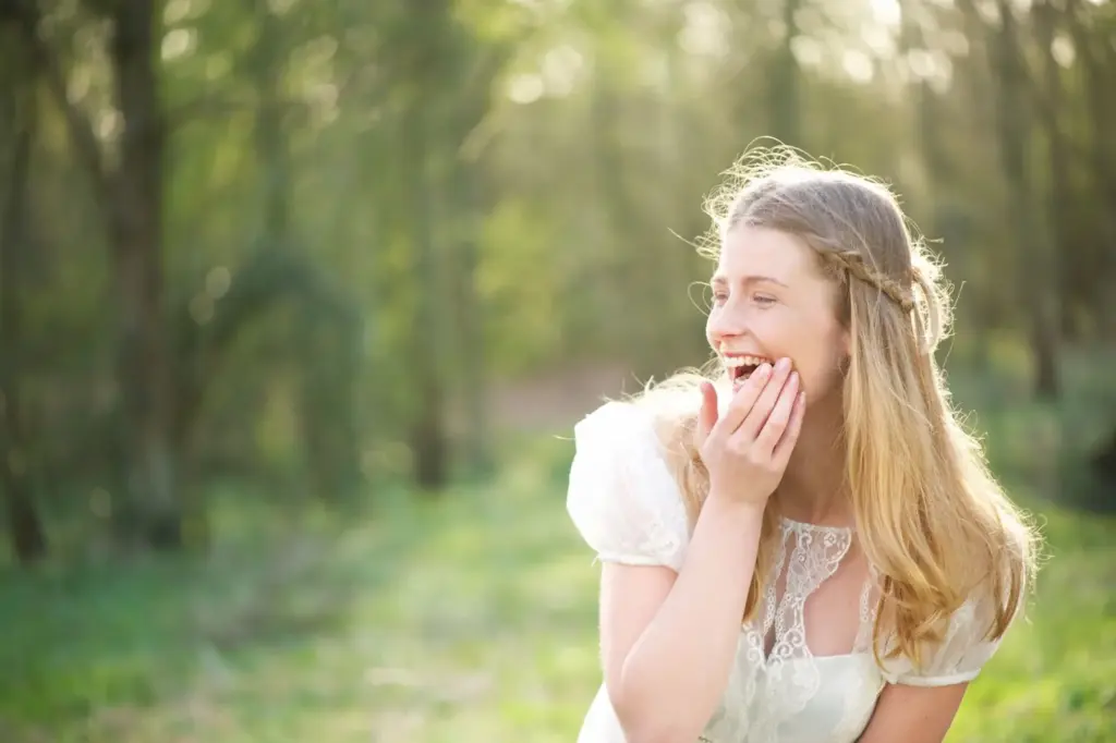 Bride giggling with her hand over her mouth