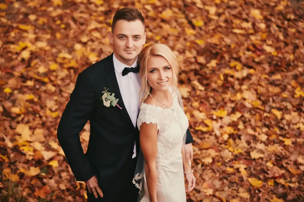 Bride & groom framed by fall foliage