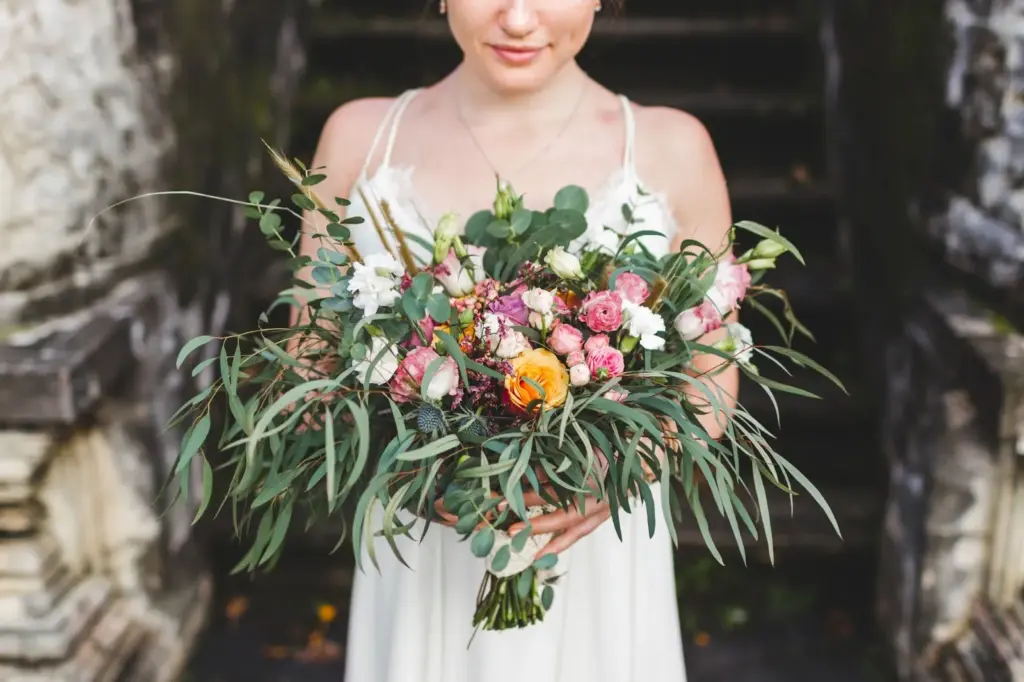 Bride holding a colorful wildflower bouquet
