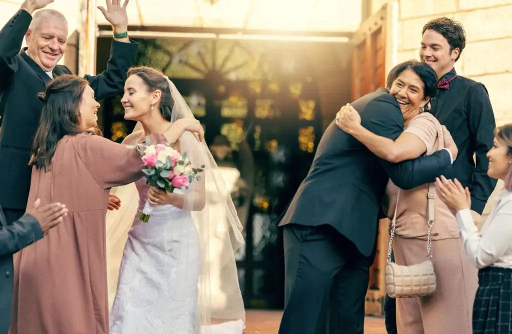 Bride hugging her parents with genuine smiles