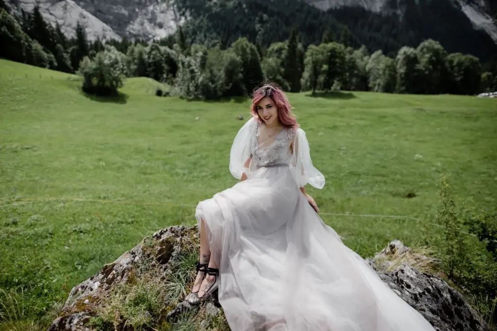 Bride sitting on a rock in her dress