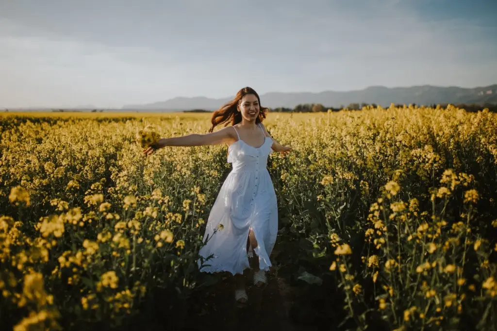 Bride spinning with her dress flowing among tall sunflowers