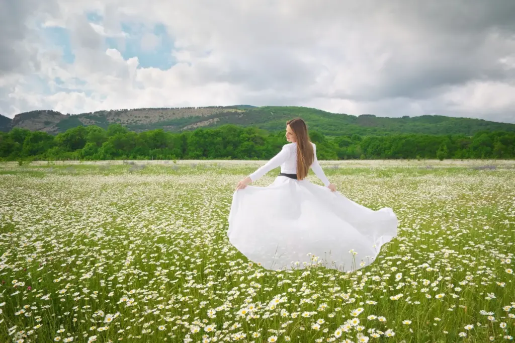 Bride twirling in an open meadow