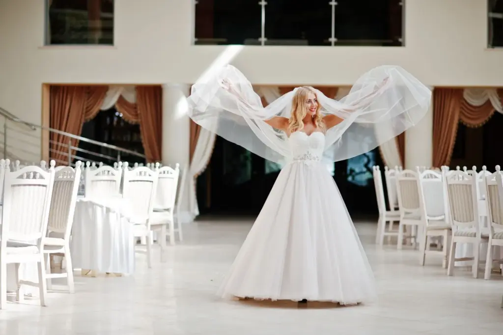 Bride twirling, with her veil floating around her