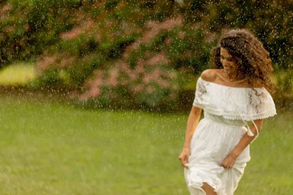 Bride’s dress flowing in the rain breeze