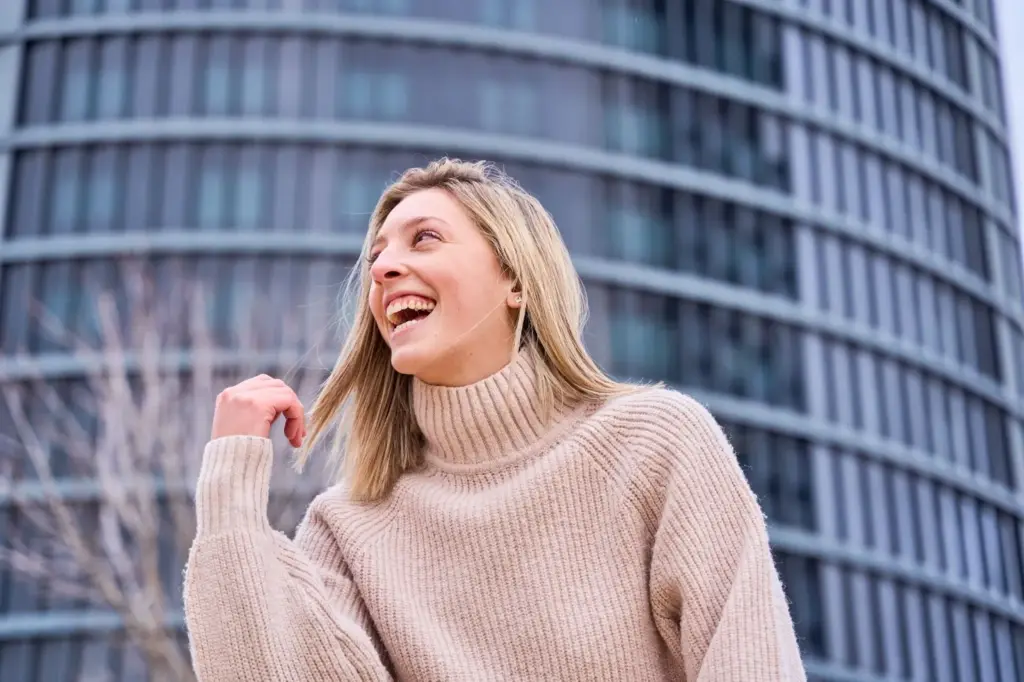 Candid laughter with tall buildings in the background