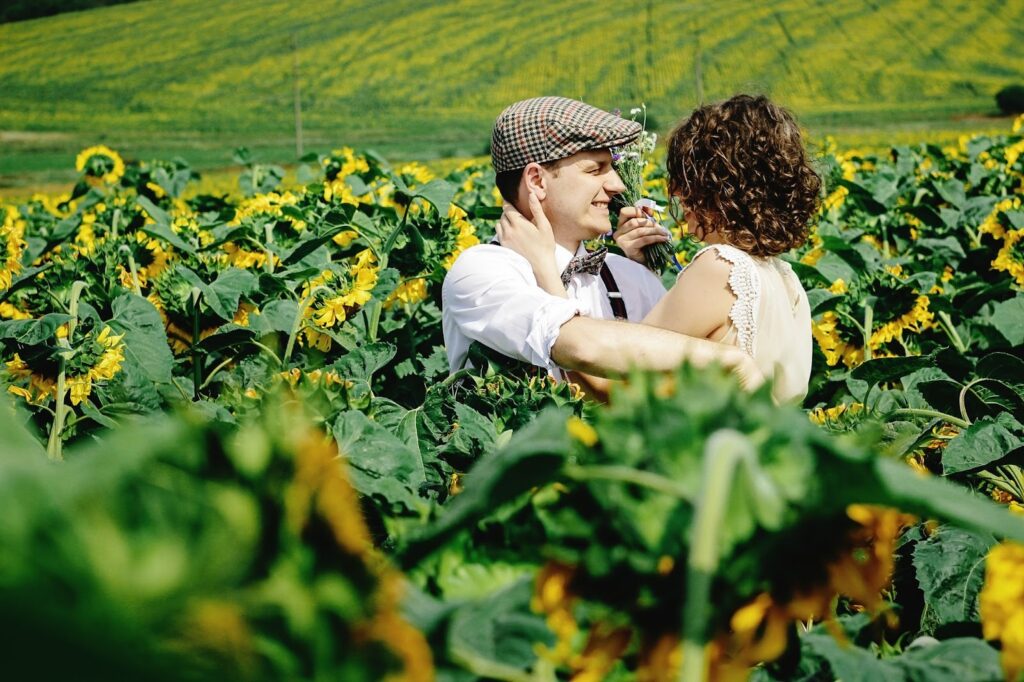 Candid moment sitting on a blanket in the sunflower field