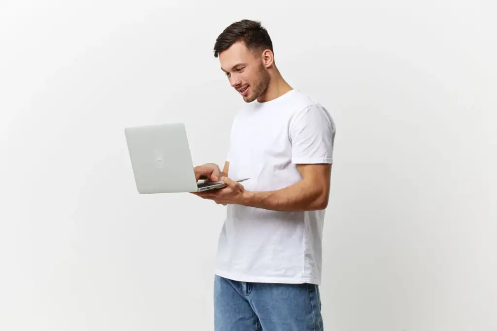 Casual T-shirt and jeans with laptop in hand