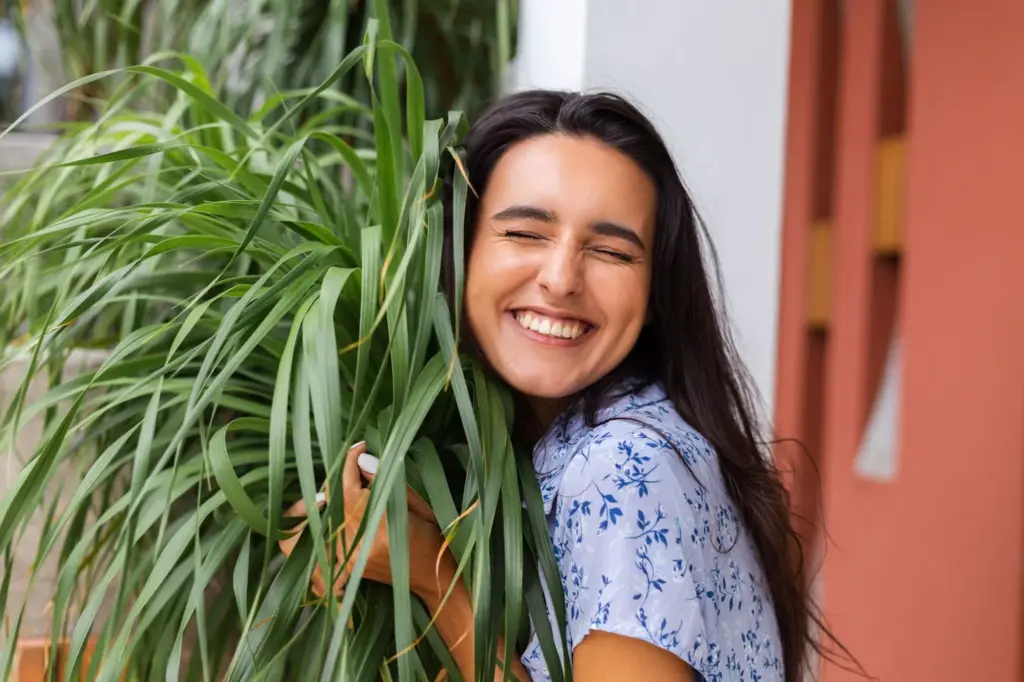 Casual smile with plants in the background