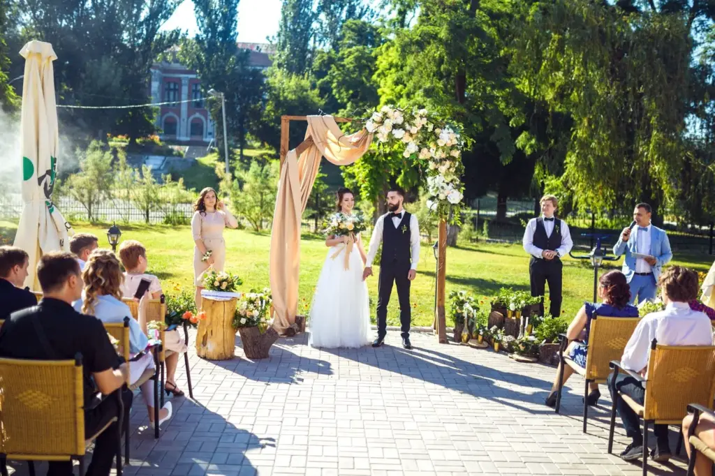 Ceremony under a wooden arch with flowers