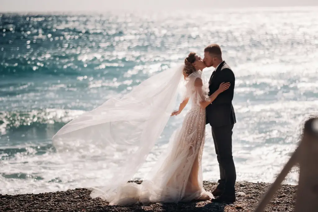 Cliffside kiss with ocean waves crashing
