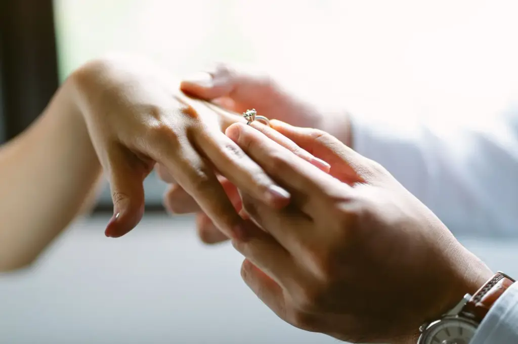 Close-up of hands sliding the rings on fingers