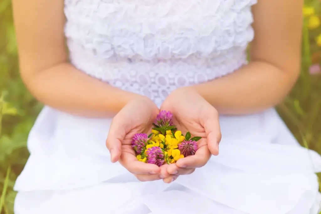 Close-up of hands with wildflowers