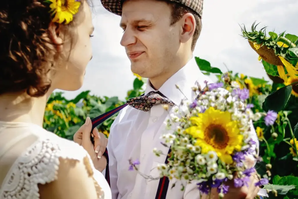 Close-up of the couple framed by sunflower blooms