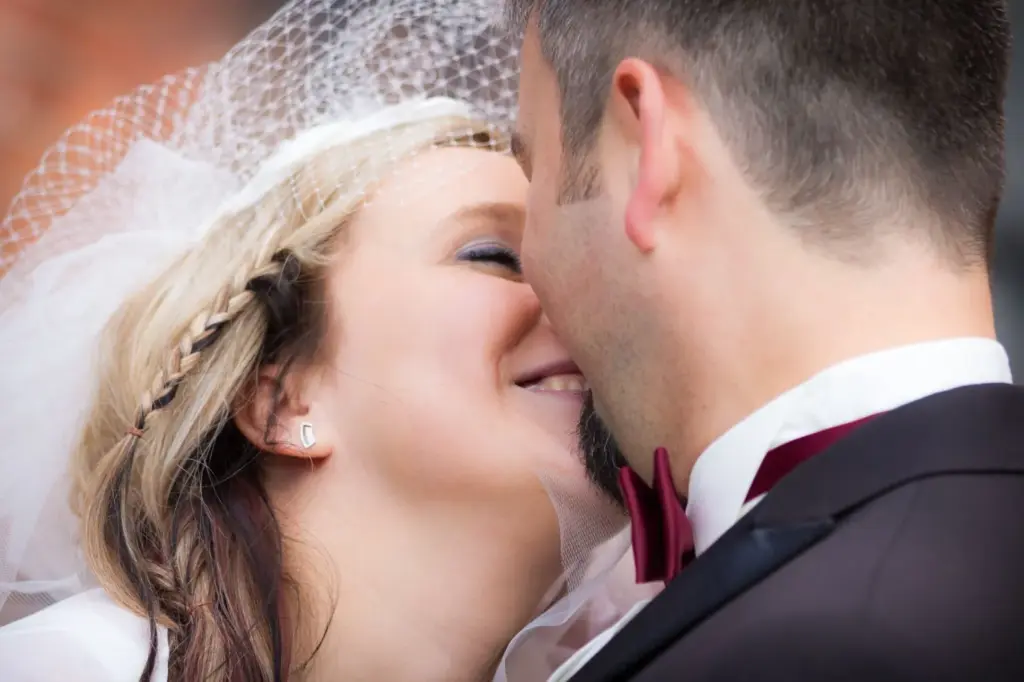 Close-up of the couple’s joyful expressions mid-whisper