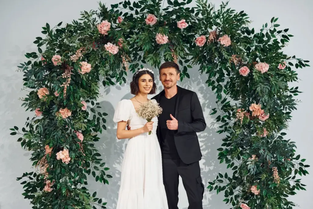 Couple framed by flower arches