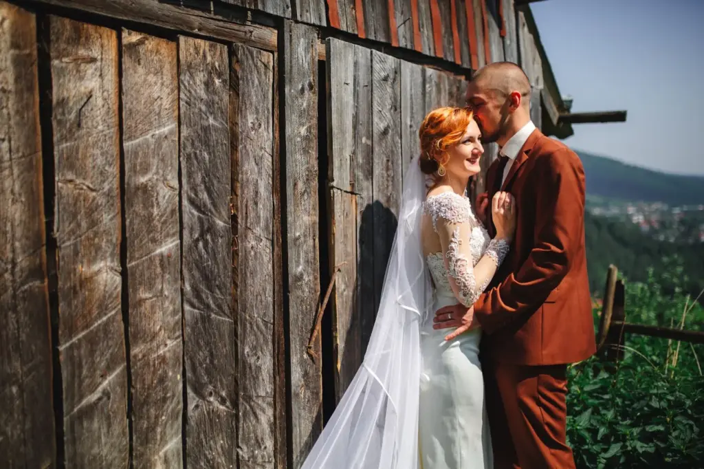 Couple in front of a weathered barn