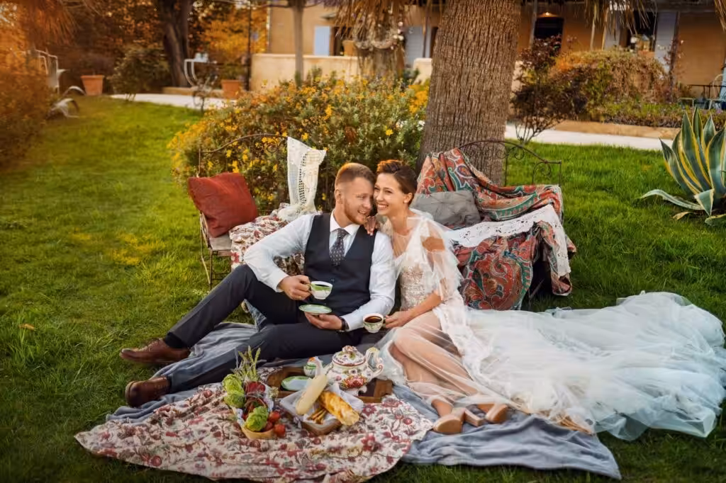 20+ Magical Outdoor Wedding Photo Ideas for Every Season 141 Couple lounging on a blanket with a picnic setup
