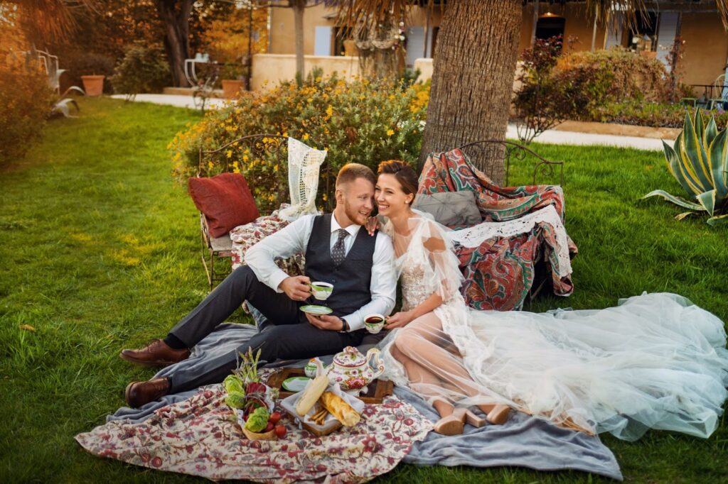Couple lounging on a blanket with a picnic setup
