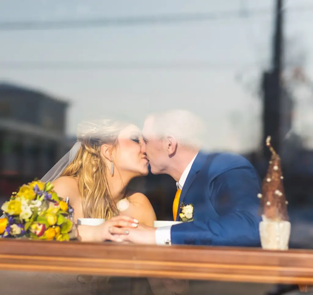Couple posing across a coffee shop window
