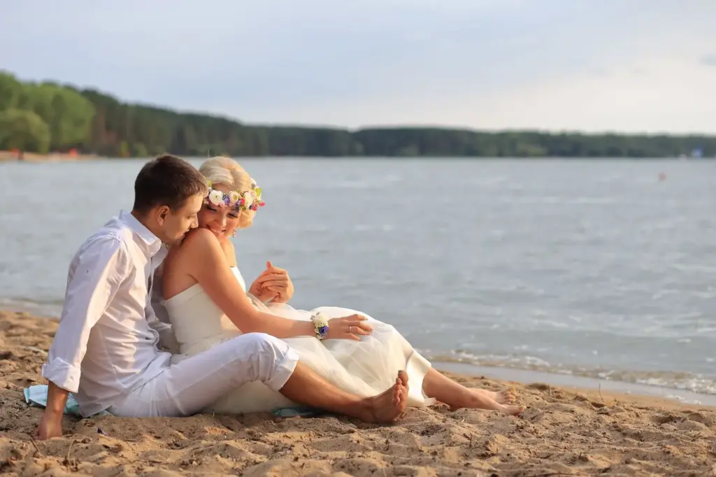 Couple sitting on the beach gazing at the horizon