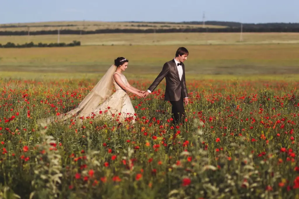 Couple walking through a wildflower field