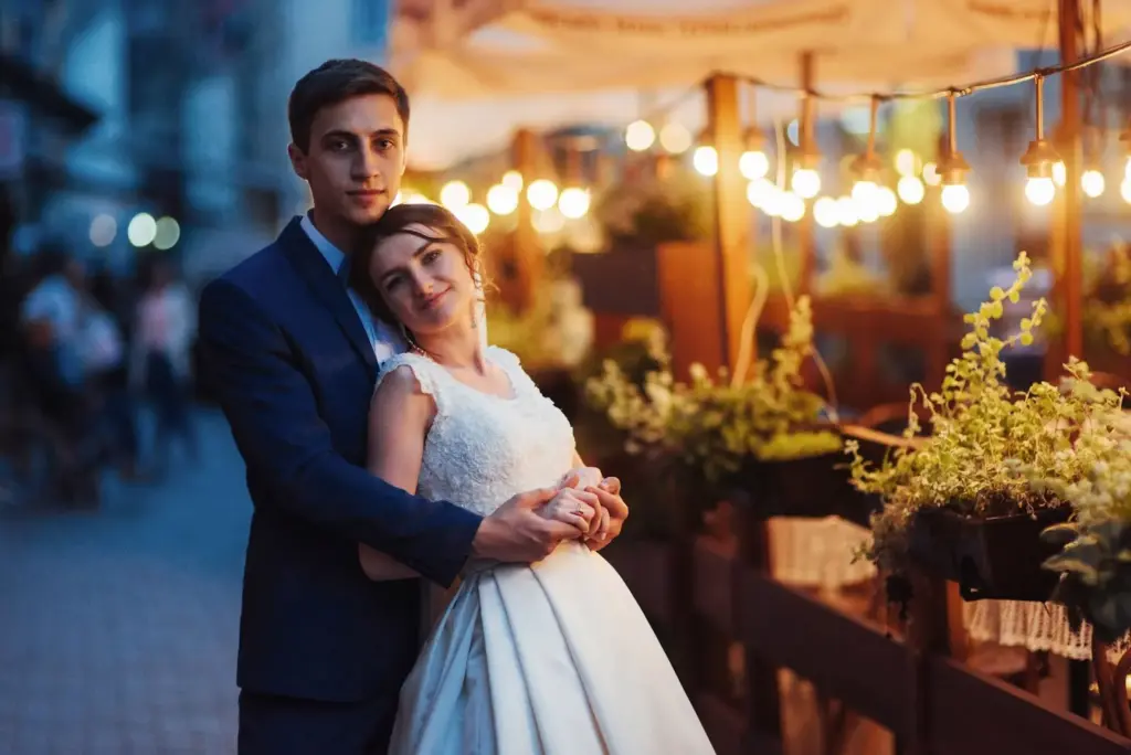 Couple with a city billboard glowing in the back