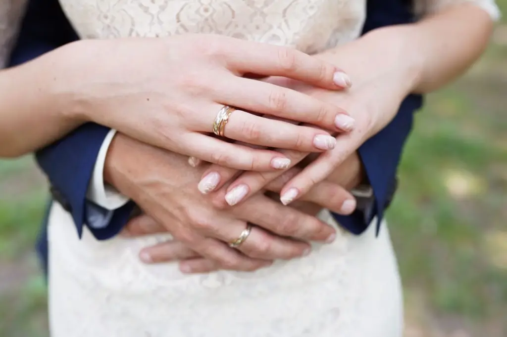 Couple with fingers intertwined