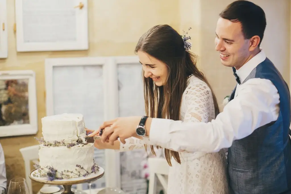 Couple’s genuine laughter while cutting cake