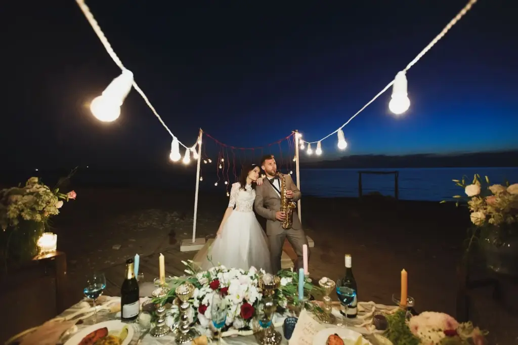 Dancing barefoot under string lights on the beach