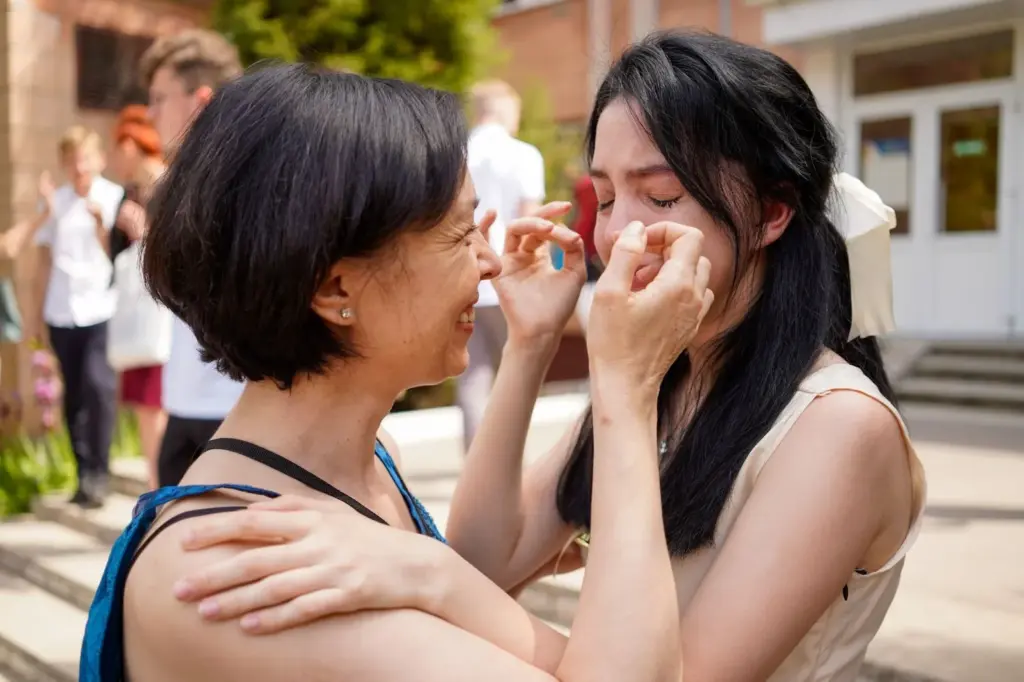 Emotional bridesmaid wiping away a tear