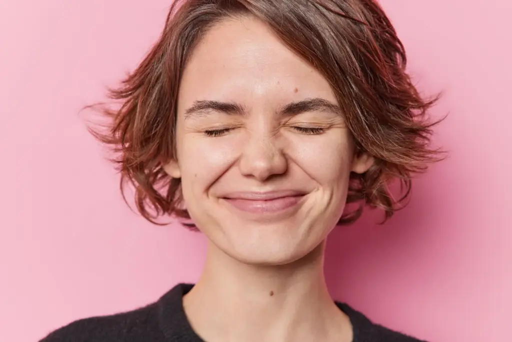 Eyes closed with a subtle smile