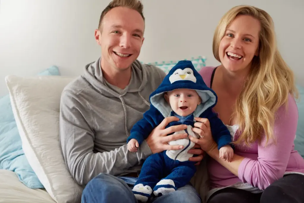 Family smiling on the couch