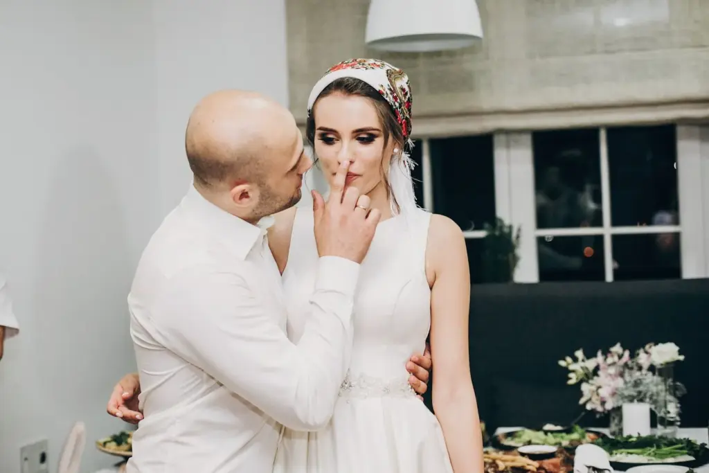 Groom whispering a funny secret to the bride