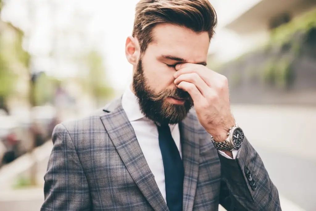 Groom wiping away a tear discreetly