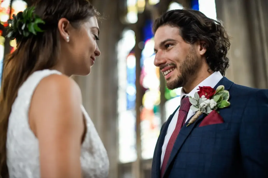 Groom’s playful grin as he leans close